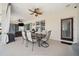 This covered patio features a ceiling fan, a table, a grill, and wicker furniture at 2814 Duncan Tree Cir, Valrico, FL 33594