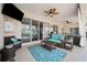 This patio features two ceiling fans, wicker furniture, a table, a grill and access to an enclosed pool area at 2814 Duncan Tree Cir, Valrico, FL 33594