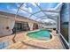 Wide angle of a screened-in pool, adjacent outdoor seating and dining, and a well maintained yard at 2814 Duncan Tree Cir, Valrico, FL 33594