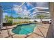Sparkling pool in a screened enclosure, surrounded by a brick patio and lush landscaping at 2814 Duncan Tree Cir, Valrico, FL 33594