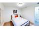 A simple bedroom features hardwood floors and white walls at 2933 Stearns Rd, Valrico, FL 33596