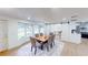 Dining room with a table set for six, large windows, and modern light fixture at 2933 Stearns Rd, Valrico, FL 33596