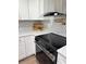 Bright kitchen features stainless steel appliances, quartz countertops, white cabinets and backsplash at 2933 Stearns Rd, Valrico, FL 33596