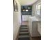 Laundry room with washer, dryer, blue accent wall, wooden shelves and storage cabinets at 2933 Stearns Rd, Valrico, FL 33596