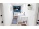 Laundry room with washer, dryer, blue accent wall, and added utility sink at 2933 Stearns Rd, Valrico, FL 33596