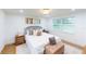 Comfortable bedroom with large window, neutral decor, and hardwood floors at 2933 Stearns Rd, Valrico, FL 33596