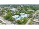 Aerial view of the property featuring colorful condominiums, lush landscaping and a parking area at 3002 W Cleveland St # D4, Tampa, FL 33609
