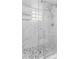 Modern bathroom with marble style tile, glass shower door, and overhead shower at 3002 W Cleveland St # D4, Tampa, FL 33609