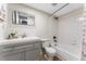 A well lit bathroom featuring white tile and an updated vanity at 3002 W Cleveland St # D4, Tampa, FL 33609