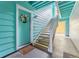 Exterior view of apartment entrance with blue siding and stairs leading to upper units at 3002 W Cleveland St # D4, Tampa, FL 33609