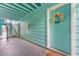 Apartment entrance with blue siding and a welcoming wreath on the door at 3002 W Cleveland St # D4, Tampa, FL 33609