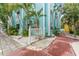 Colorful condominium property featuring lush tropical landscaping with palm trees and unique painted exteriors at 3002 W Cleveland St # D4, Tampa, FL 33609