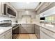 Well-lit kitchen features stainless appliances, tile floors, ample counter space and gray cabinets at 3002 W Cleveland St # D4, Tampa, FL 33609