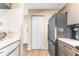 A spacious kitchen with stainless appliances, gray cabinets and tile floors at 3002 W Cleveland St # D4, Tampa, FL 33609