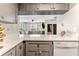 Modern kitchen with views to living room, gray cabinets, stainless appliances and tile floors at 3002 W Cleveland St # D4, Tampa, FL 33609