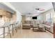 Open-concept living area with bar seating, cozy sectional sofa, and a large mirrored wall at 3002 W Cleveland St # D4, Tampa, FL 33609