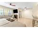 Spacious living room with a large sectional sofa, ceiling fans, and a sliding door to balcony at 3002 W Cleveland St # D4, Tampa, FL 33609