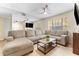 Comfortable living room featuring a neutral sectional sofa, a coffee table, and a TV at 3002 W Cleveland St # D4, Tampa, FL 33609