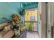 Enclosed porch with a peek at some lush landscaping, storage and a teal color scheme at 3002 W Cleveland St # D4, Tampa, FL 33609