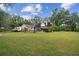 Large backyard with an RV trailer, pool, pergola, and lush landscaping at 3018 Pemberton Trace Ct, Plant City, FL 33565