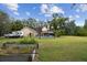 Well-maintained backyard featuring an above-ground pool and large green space at 3018 Pemberton Trace Ct, Plant City, FL 33565
