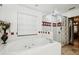 This bathroom features a luxurious soaking tub, a tiled surround, and a glass-enclosed shower at 3018 Pemberton Trace Ct, Plant City, FL 33565
