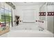This bathroom features a luxurious soaking tub, a tiled surround, and a glass-enclosed shower at 3018 Pemberton Trace Ct, Plant City, FL 33565