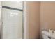 The bathroom features a walk-in shower with glass doors and neutral-toned walls at 3018 Pemberton Trace Ct, Plant City, FL 33565