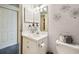 Bright bathroom with white fixtures, decorative mirror, and a basket of toiletries at 3018 Pemberton Trace Ct, Plant City, FL 33565