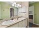 Bathroom featuring double sinks, a vanity with storage, and decorative accents at 3018 Pemberton Trace Ct, Plant City, FL 33565