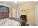 Well-lit bedroom with a ceiling fan, and a bed with floral bedding and writing desk at 3018 Pemberton Trace Ct, Plant City, FL 33565
