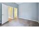 Bedroom with carpet, closet, light blue walls, and access to other rooms at 3018 Pemberton Trace Ct, Plant City, FL 33565
