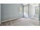 Spacious bedroom with gray carpet, closet, and a window offering natural light at 3018 Pemberton Trace Ct, Plant City, FL 33565