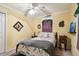Cozy bedroom featuring a ceiling fan, a bed with patterned bedding, and yellow painted walls at 3018 Pemberton Trace Ct, Plant City, FL 33565