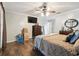 Spacious bedroom with hardwood floors and simple decor including a dresser and wall mirror at 3018 Pemberton Trace Ct, Plant City, FL 33565