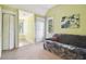 Cozy bonus room with a sleeper sofa, a vaulted ceiling, and multiple doors offering versatility at 3018 Pemberton Trace Ct, Plant City, FL 33565
