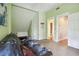 Cozy bonus room featuring a plush futon and a doorway leading to a bathroom at 3018 Pemberton Trace Ct, Plant City, FL 33565