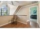 Bright, airy bonus room with hardwood floors, vaulted ceilings, and a charming rocking chair near a large window at 3018 Pemberton Trace Ct, Plant City, FL 33565
