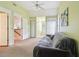 Versatile bonus room with vaulted ceilings, three doors, and a comfortable sleeper sofa for relaxation at 3018 Pemberton Trace Ct, Plant City, FL 33565