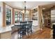 Cozy breakfast nook with bay windows providing natural light and seating with black wooden chairs at 3018 Pemberton Trace Ct, Plant City, FL 33565