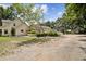 Exterior view of a home with trees, RV, and gravel driveway at 3018 Pemberton Trace Ct, Plant City, FL 33565