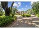 Spacious property showcasing a charming two-story home with a long driveway and lush landscaping, offering serene privacy at 3018 Pemberton Trace Ct, Plant City, FL 33565
