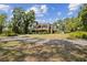 Spacious property showcasing a charming two-story home with a long driveway and lush landscaping, offering serene privacy at 3018 Pemberton Trace Ct, Plant City, FL 33565