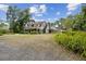 Spacious property showcasing a charming two-story home with a long driveway and lush landscaping, offering serene privacy at 3018 Pemberton Trace Ct, Plant City, FL 33565