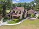 Aerial view of charming home with mature landscaping, a porch and a long driveway at 3018 Pemberton Trace Ct, Plant City, FL 33565
