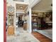Grand foyer with tile flooring transitions into hardwood, offering views of a living room and bar area with a piano at 3018 Pemberton Trace Ct, Plant City, FL 33565
