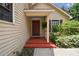 Inviting front porch with a red-painted porch, window, and lush landscaping at 3018 Pemberton Trace Ct, Plant City, FL 33565
