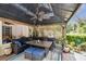 Inviting covered gazebo with wicker sofa, table, ceiling fan and outdoor rug at 3018 Pemberton Trace Ct, Plant City, FL 33565