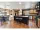Open kitchen with island, stainless steel appliances, breakfast nook, and seamless flow to the adjacent room at 3018 Pemberton Trace Ct, Plant City, FL 33565