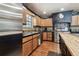 Well-lit kitchen featuring stainless steel appliances, wooden cabinetry, and sleek countertops at 3018 Pemberton Trace Ct, Plant City, FL 33565
